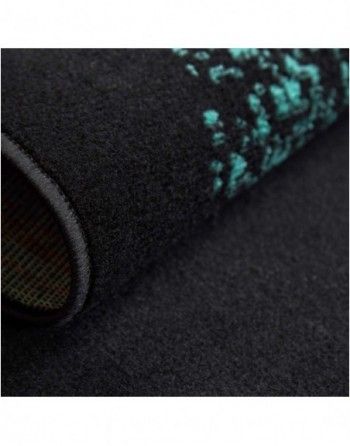 A close up of a black rug with blue spots on it.