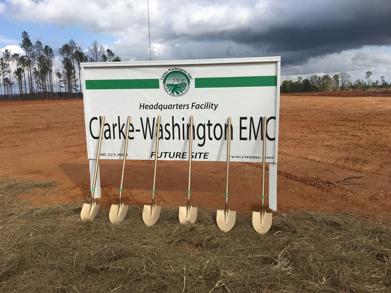 A sign for clarke-washington emc is surrounded by shovels