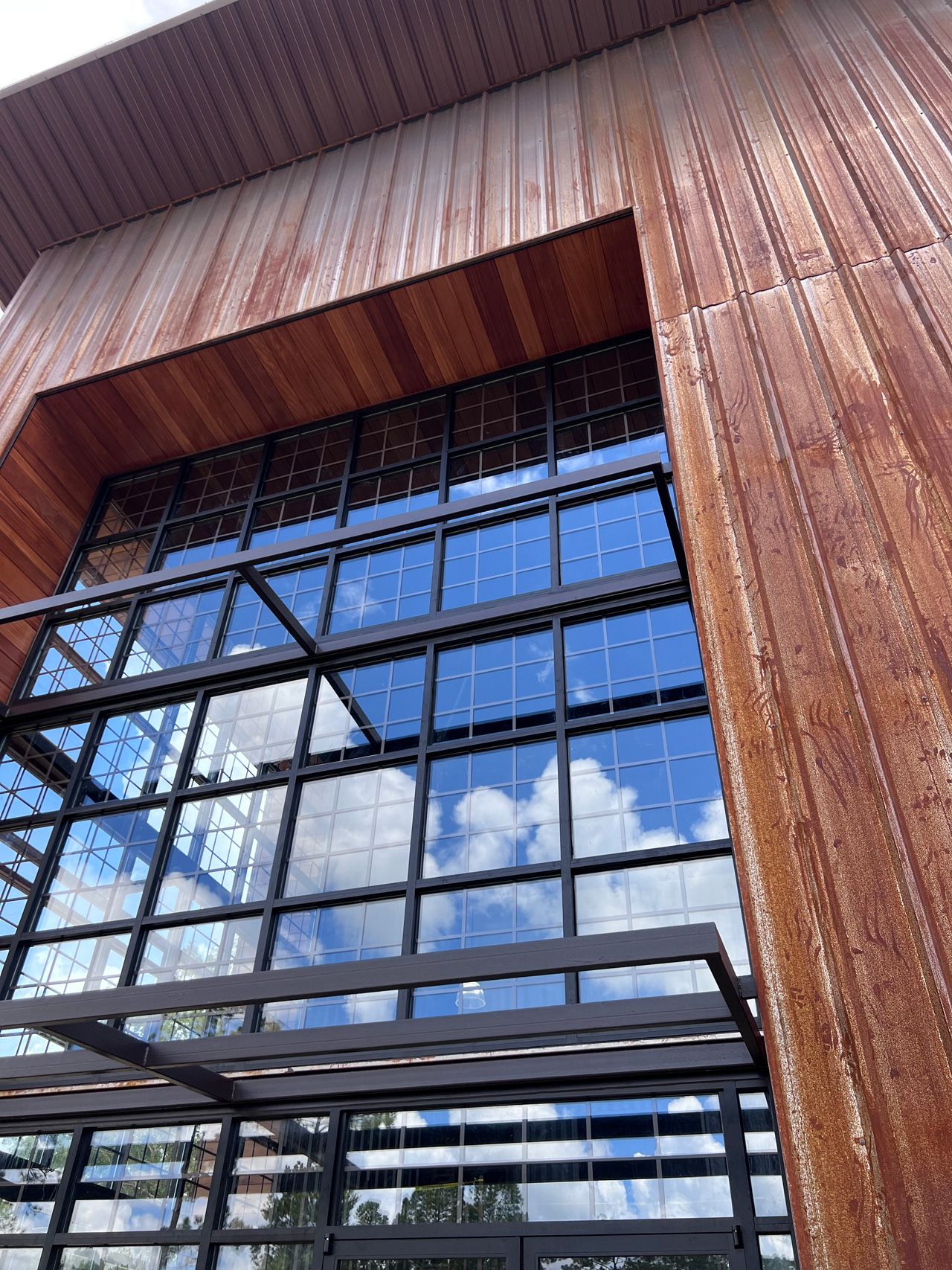 A large building with a lot of windows and a wooden roof.