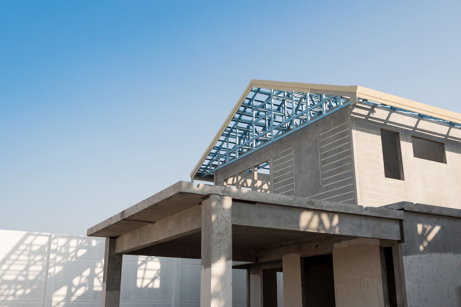 A house under construction with a blue sky in the background