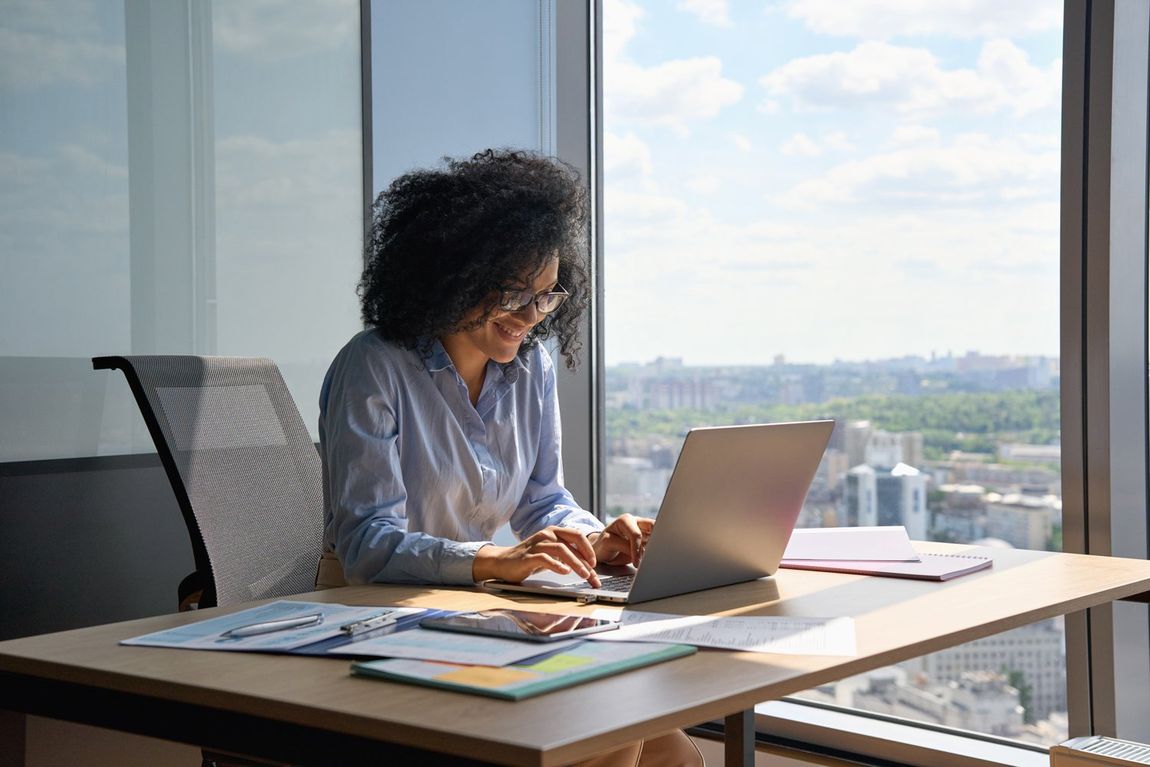 Woman Reading News on Her Laptop
