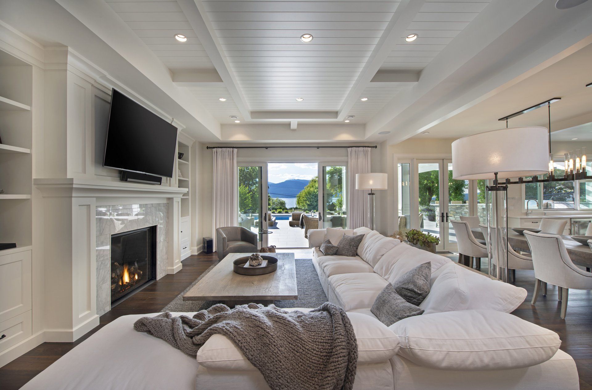 a living room with a couch , fireplace and television .