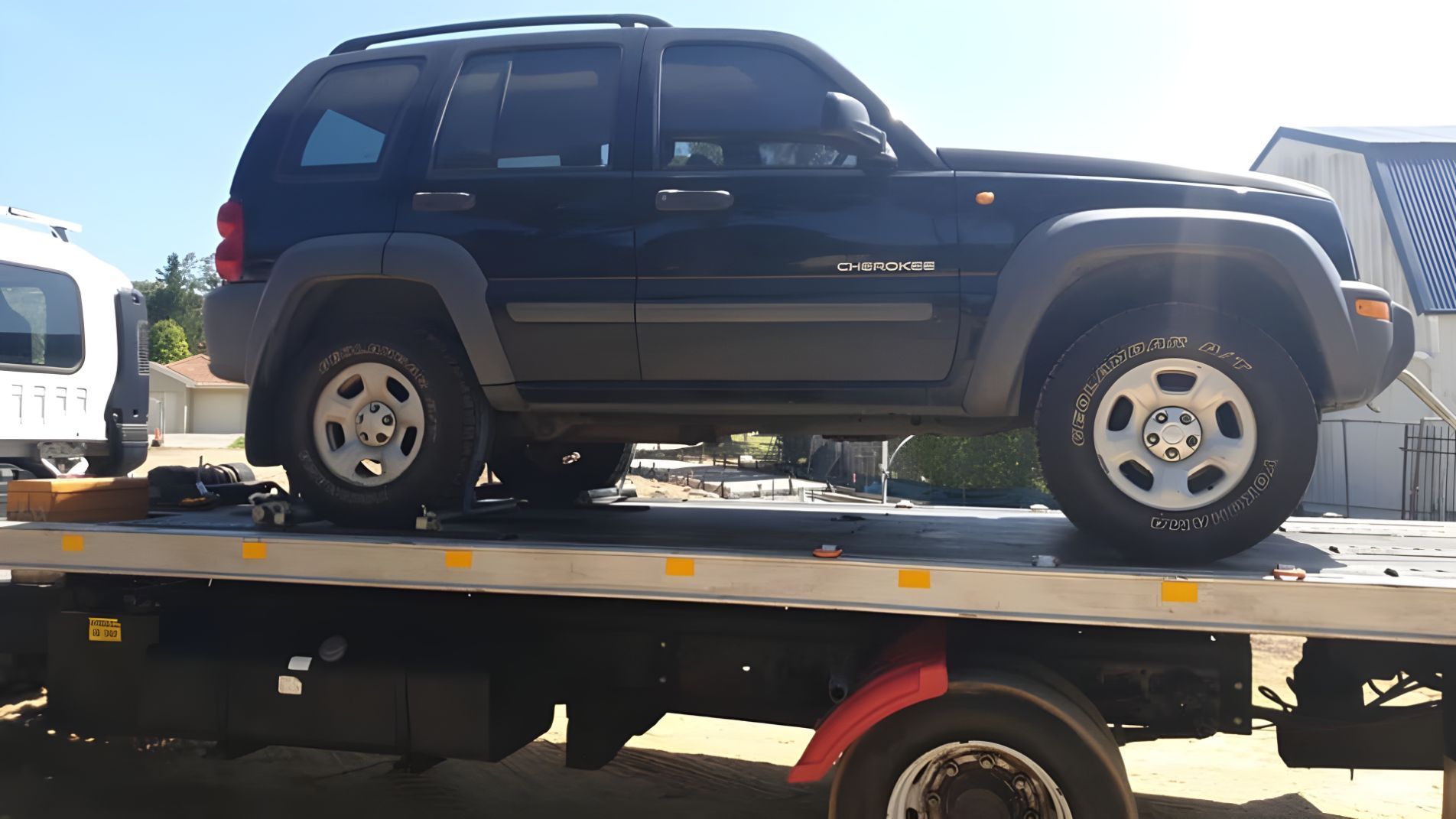 Black Suv is Sitting on Top of a Tow Truck — NCM Towing Newcastle In Singleton, NSW