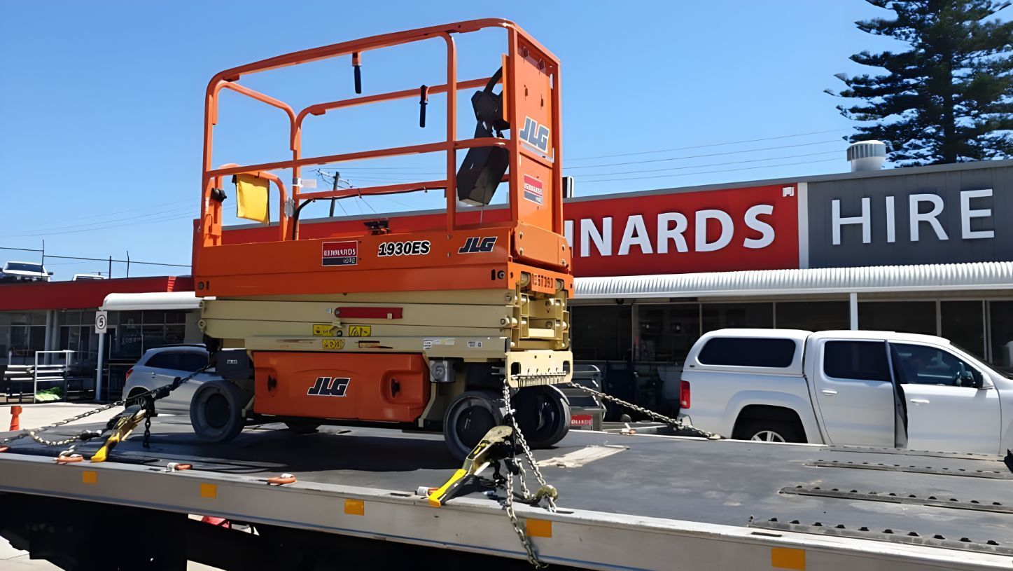 Orange Scissor Lift is Sitting on Top of a Tow Truck — NCM Towing Newcastle In Broadmeadow, NSW