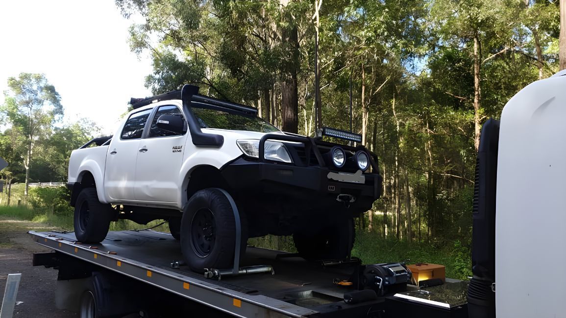White Truck is Sitting on Top of a Tow Truck — NCM Towing Newcastle In Nelson Bay, NSW