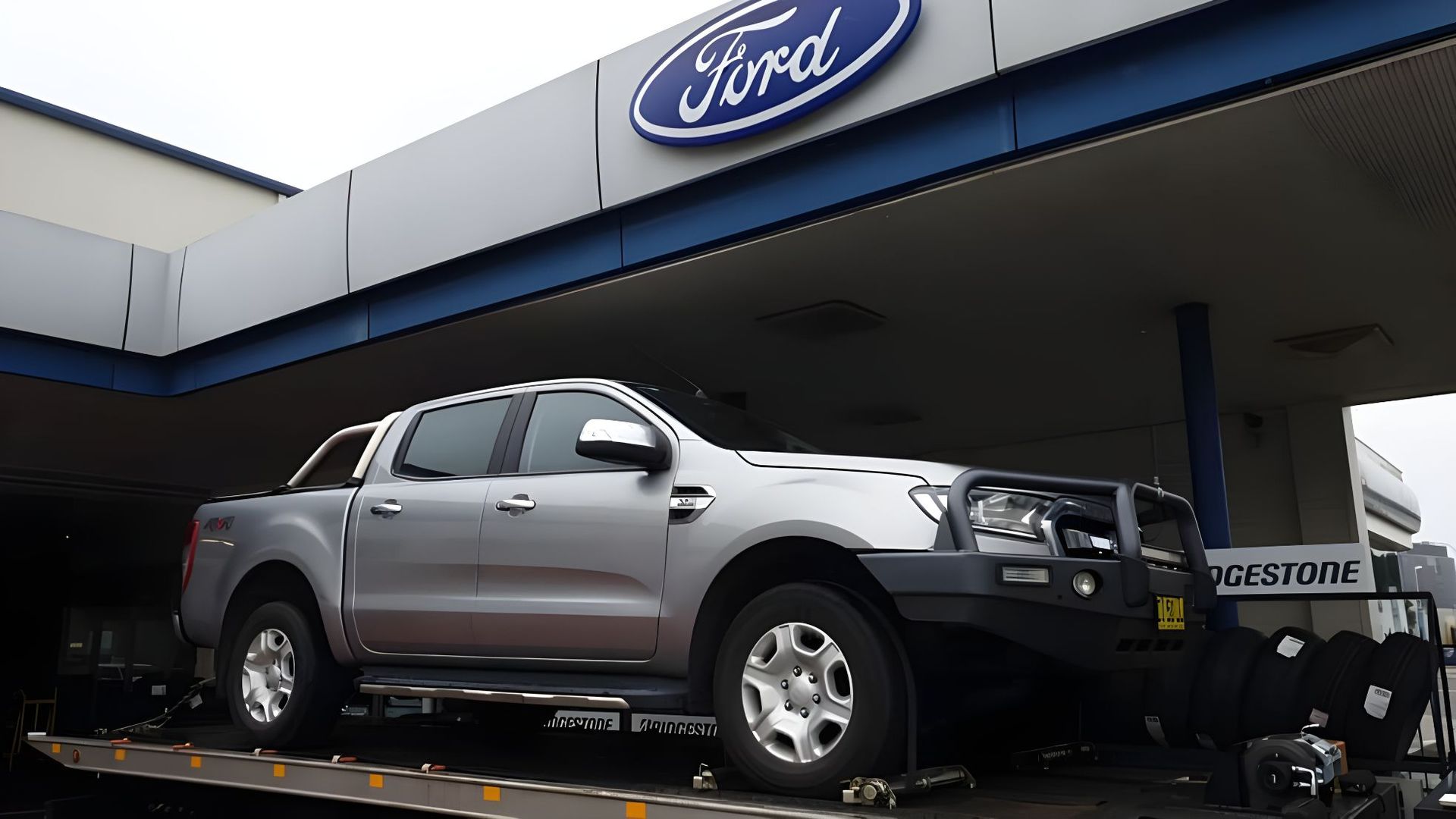 Silver Ford Truck is Parked in Front of a Ford Dealership — NCM Towing Newcastle In Maitland, NSW