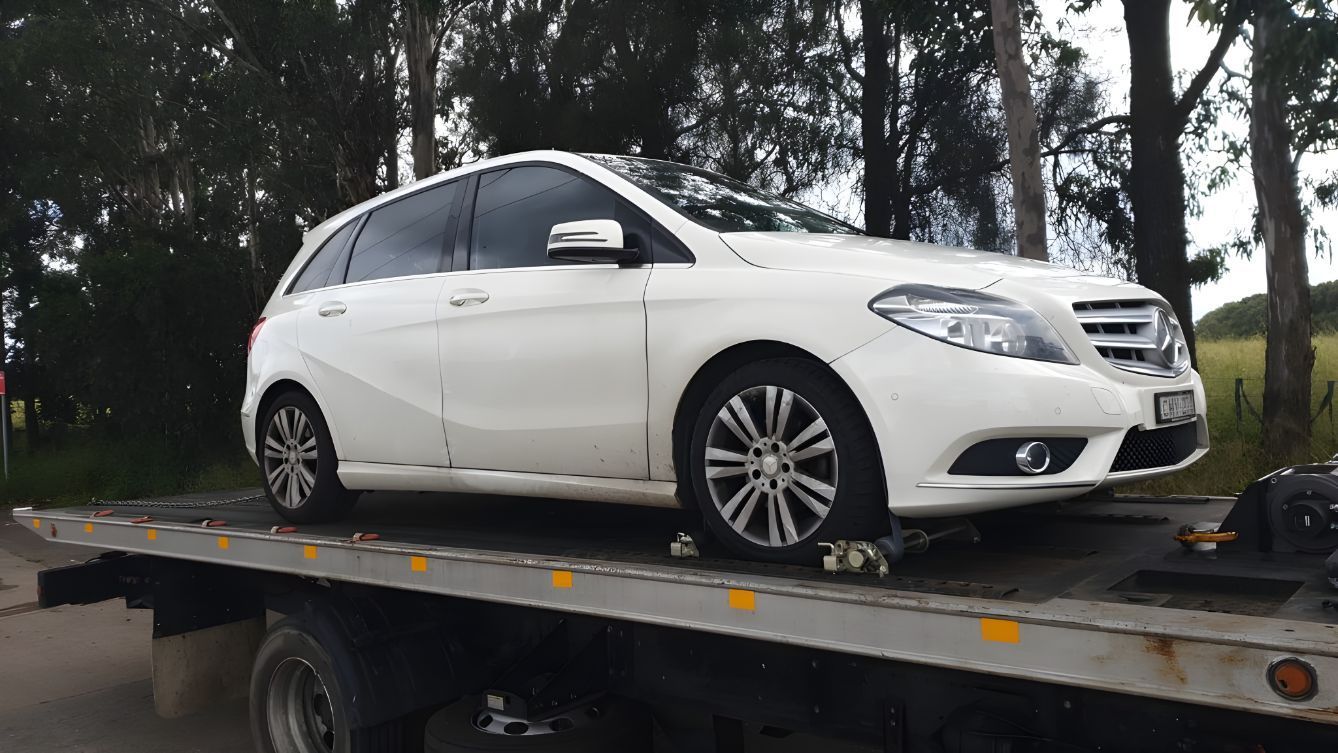 White Car is Sitting on Top of a Tow Truck — NCM Towing Newcastle In Cessnock, NSW