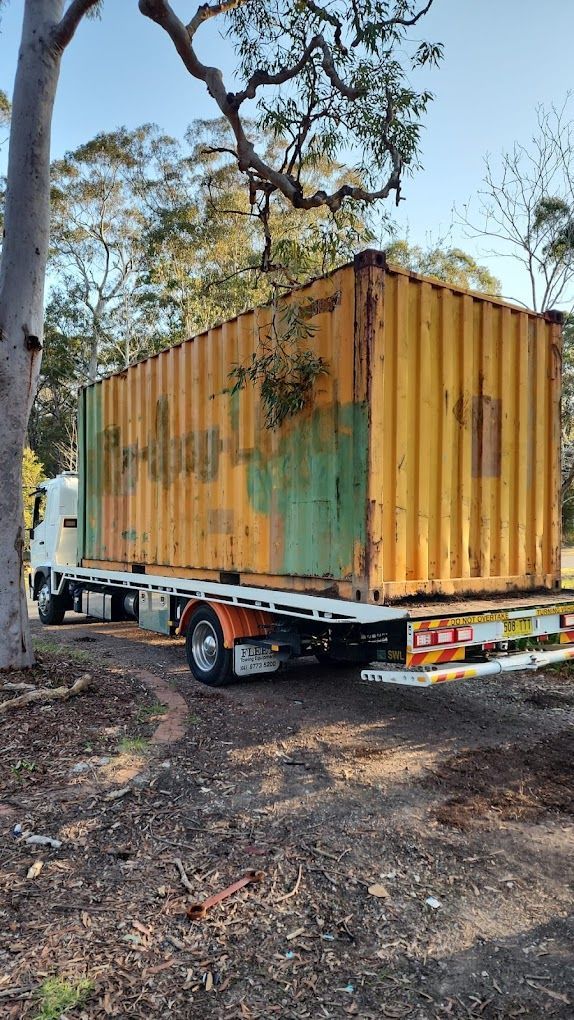 Truck is Being Loaded With a Container in a Warehouse — NCM Towing Newcastle In Broadmeadow, NSW
