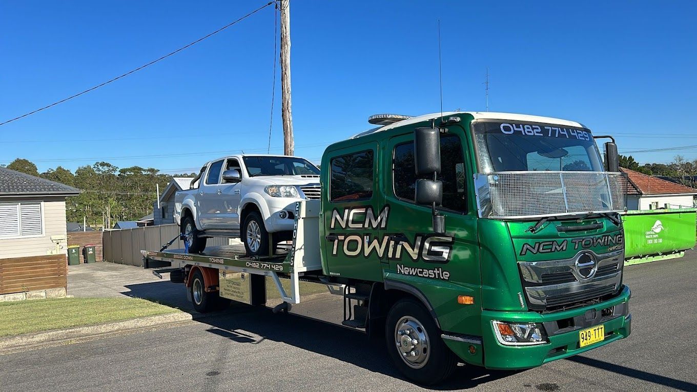 White Ute is Sitting on Top of a Tow Truck — NCM Towing Newcastle In Broadmeadow, NSW