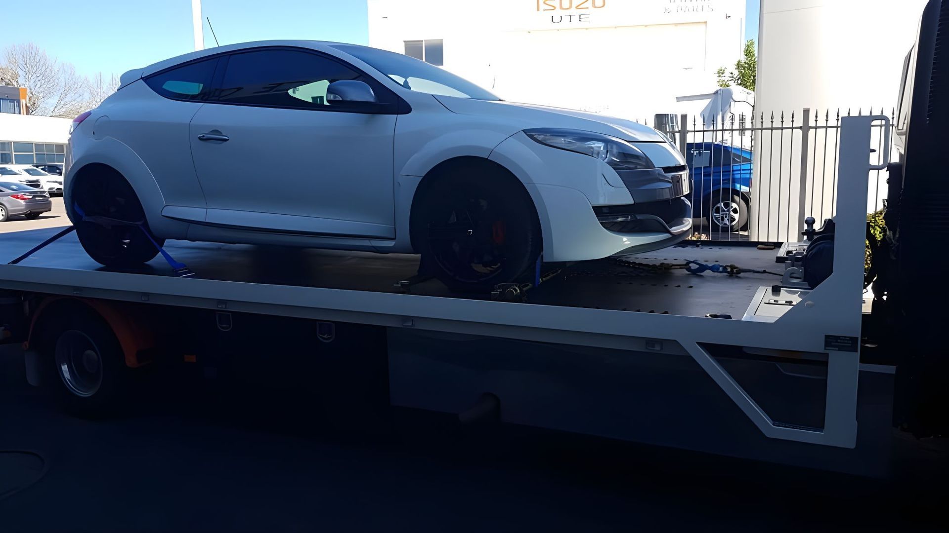White Car is Sitting on Top of a Tow Truck — NCM Towing Newcastle In Toronto, NSW