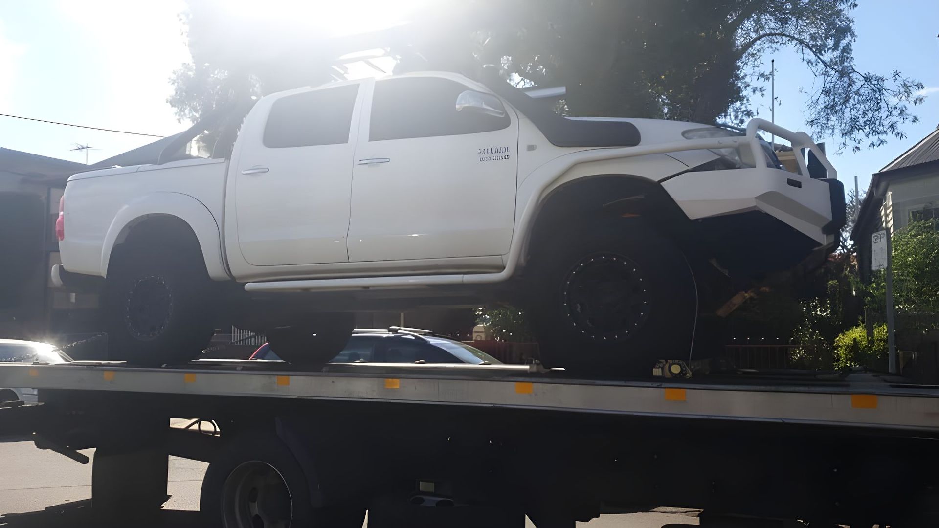 White Truck is Sitting on Top of a Tow Truck — NCM Towing Newcastle In Singleton, NSW