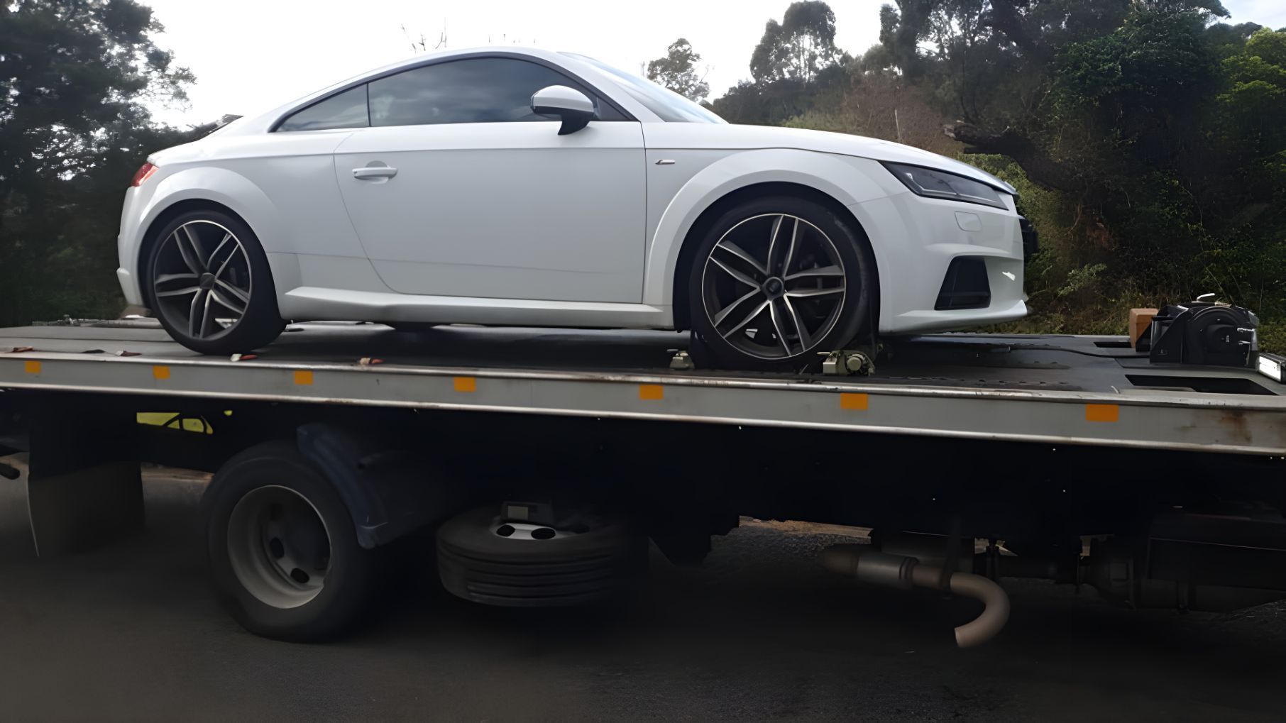 White Car is Sitting on Top of a Tow Truck — NCM Towing Newcastle In Broadmeadow, NSW