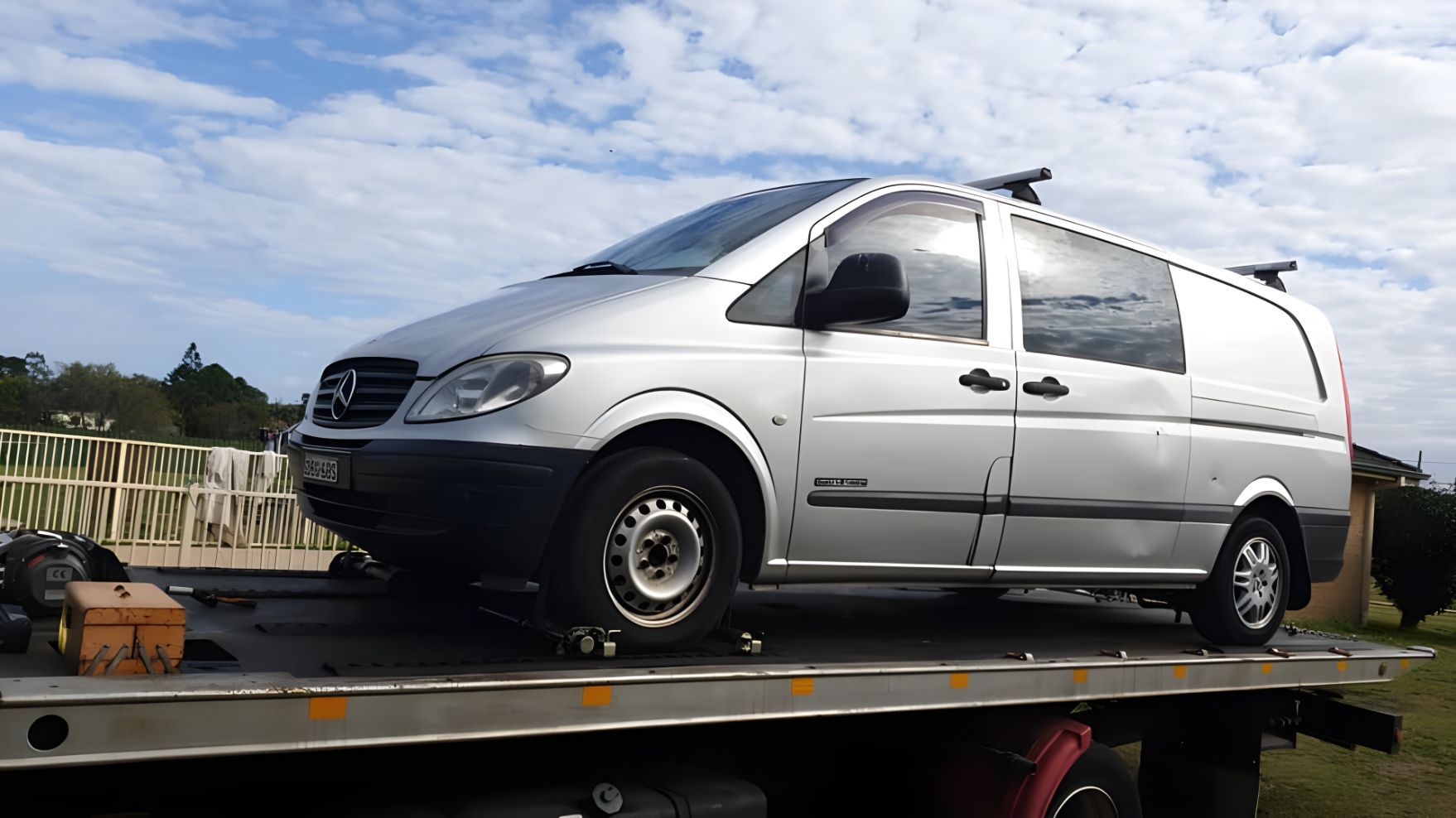 White Van is Sitting on Top of a Tow Truck — NCM Towing Newcastle In Broadmeadow, NSW