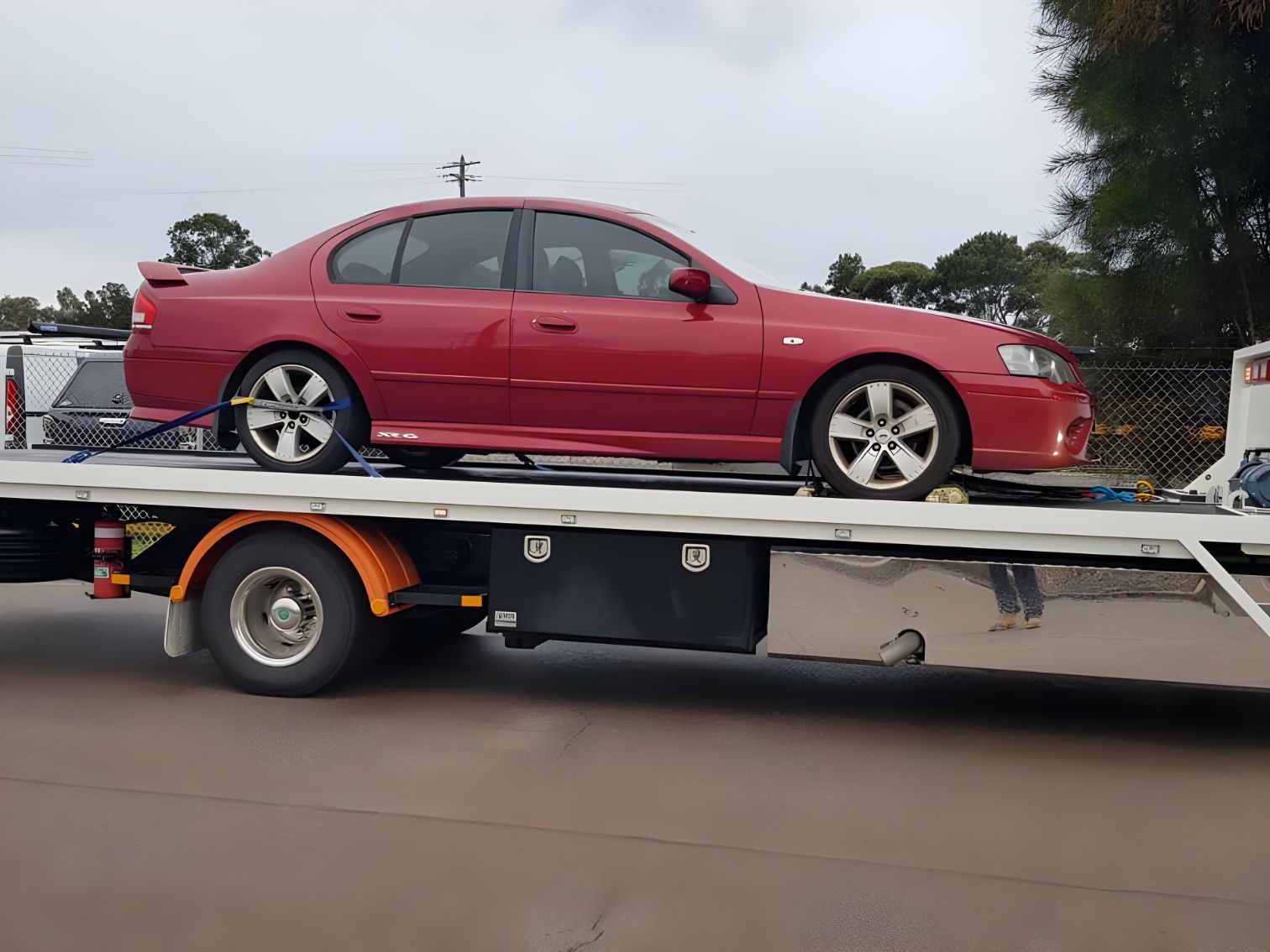 Red Car is Sitting on Top of a Tow Truck — NCM Towing Newcastle In Hunter Valley, NSW
