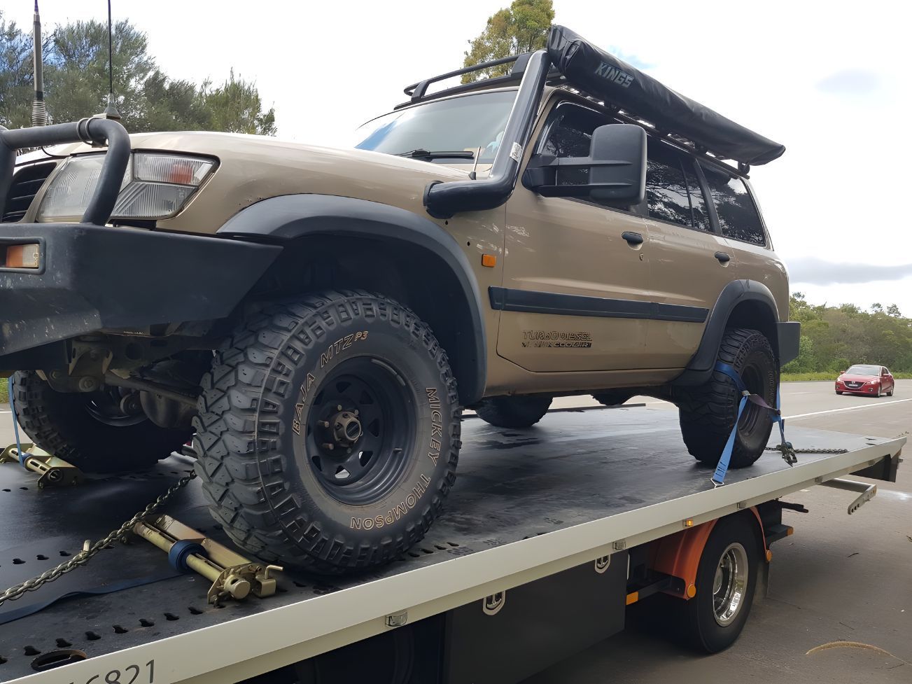 Toyota Land Cruiser is Being Towed by a Tow Truck — NCM Towing Newcastle In Broadmeadow, NSW