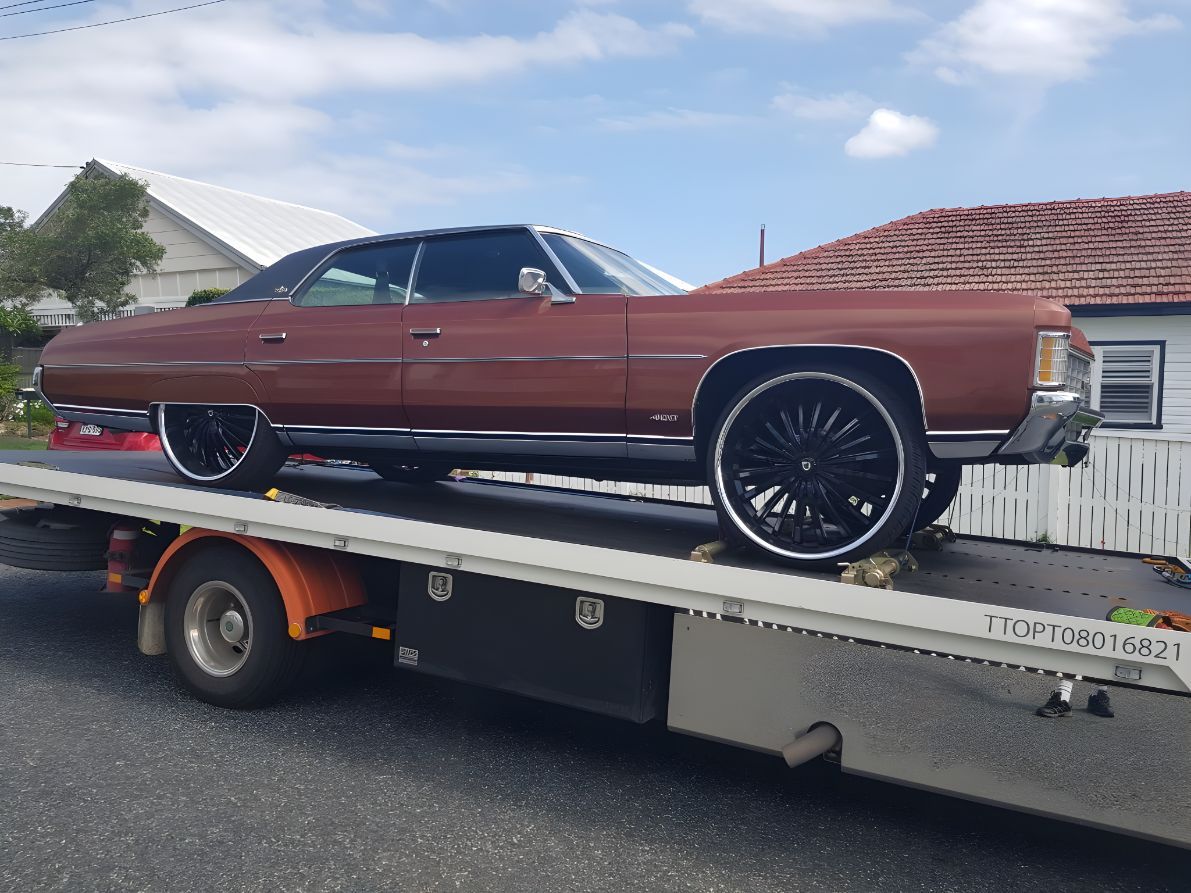 Brown Car is Sitting on Top of a Tow Truck — NCM Towing Newcastle In Medowie, NSW