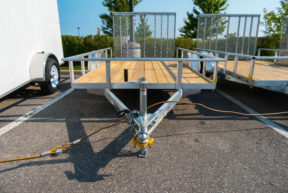 Trailer With a Wooden Deck is Parked in a Parking Lot — NCM Towing Newcastle In Broadmeadow, NSW