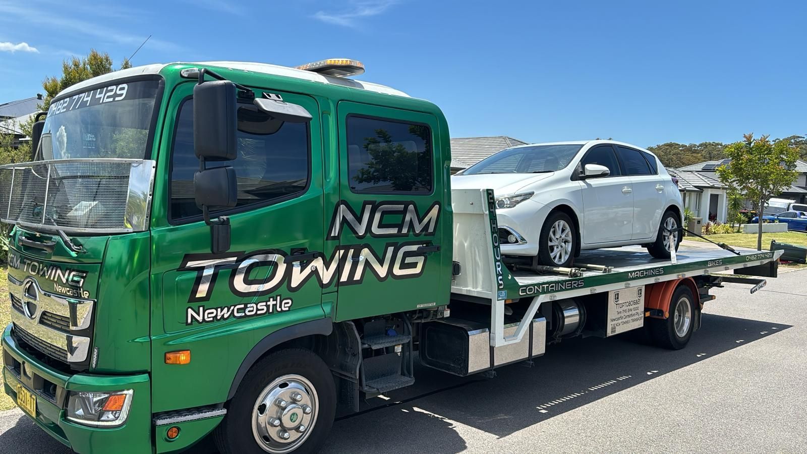 White Car is Sitting on Top of a Tow Truck — NCM Towing Newcastle In Broadmeadow, NSW