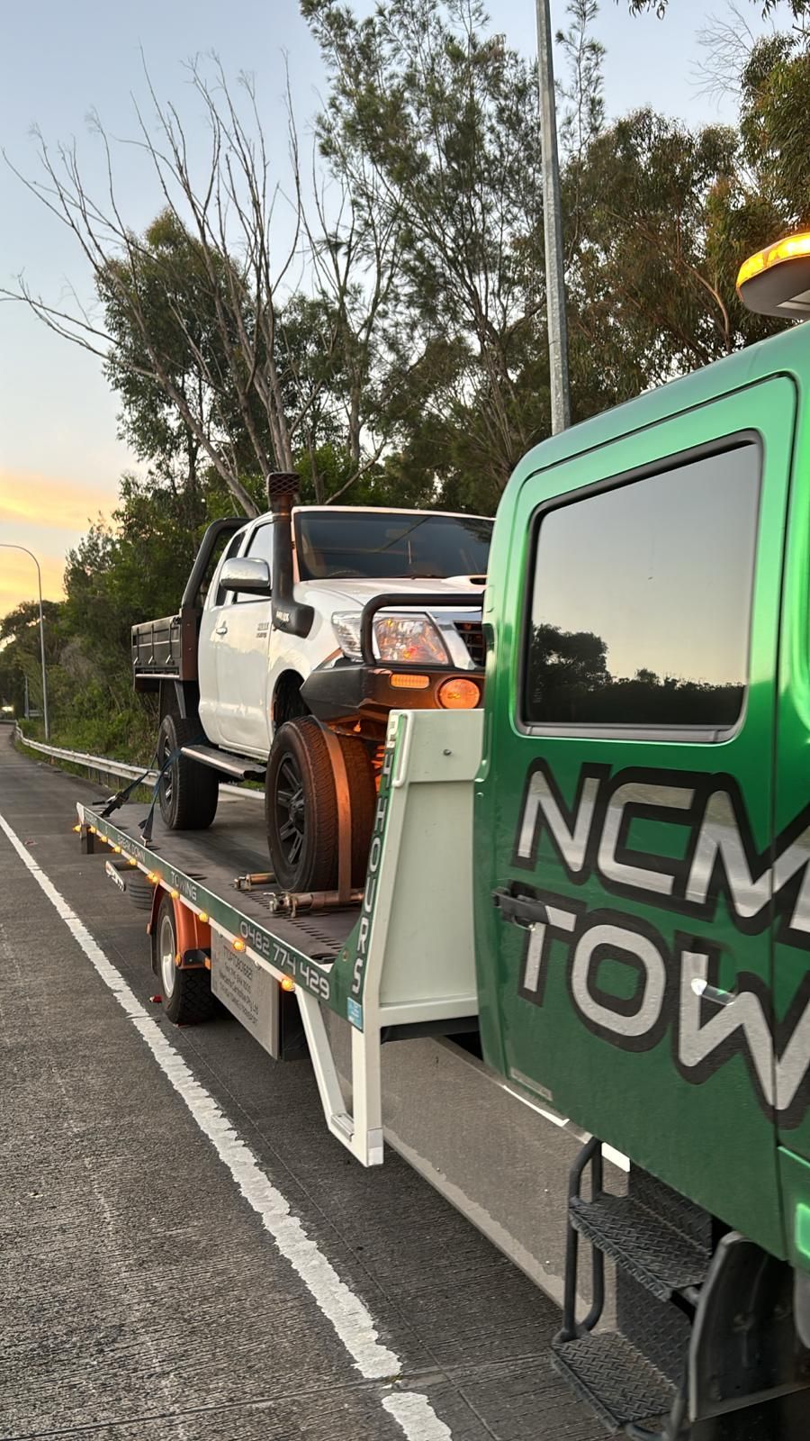 White Ute is Sitting on Top of a Tow Truck — NCM Towing Newcastle In Broadmeadow, NSW