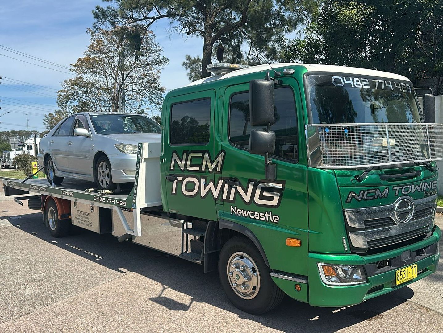 Silver Car is Being Towed by a Tow Truck — NCM Towing Newcastle In Broadmeadow, NSW