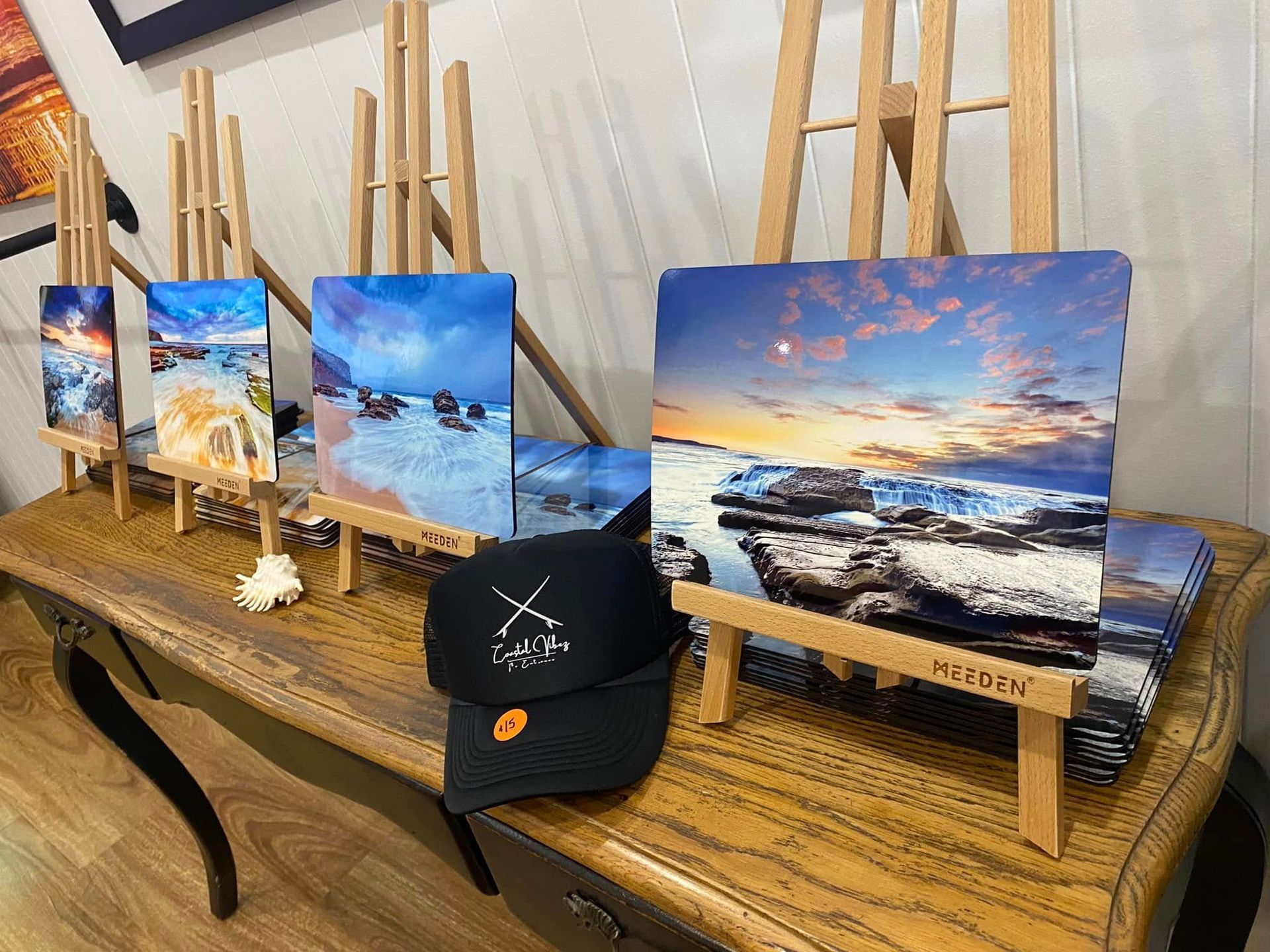 Landscape Paintings On Easels Displayed On A Shelf — Coastal Vibez In Ourimbah, NSW