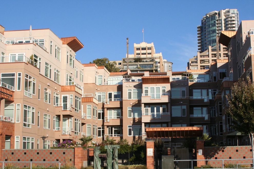 Modern apartment buildings with balconies under a clear blue sky Modern apartment buildings with balconies under a clear blue sky