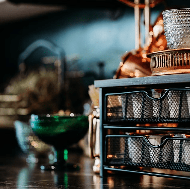 A shelf with drawers filled with cups on a table