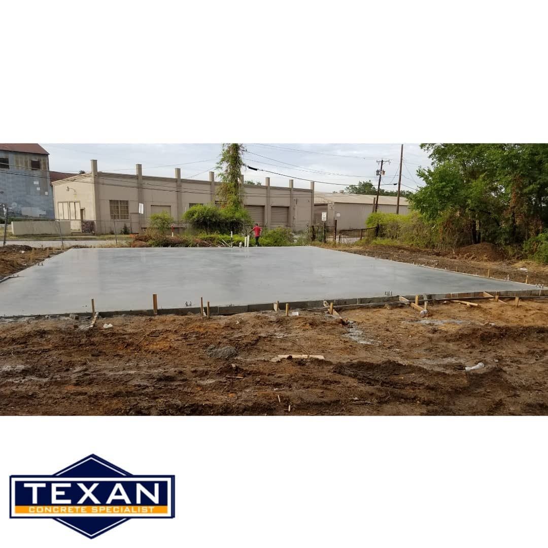 A large concrete slab is being built by texan
