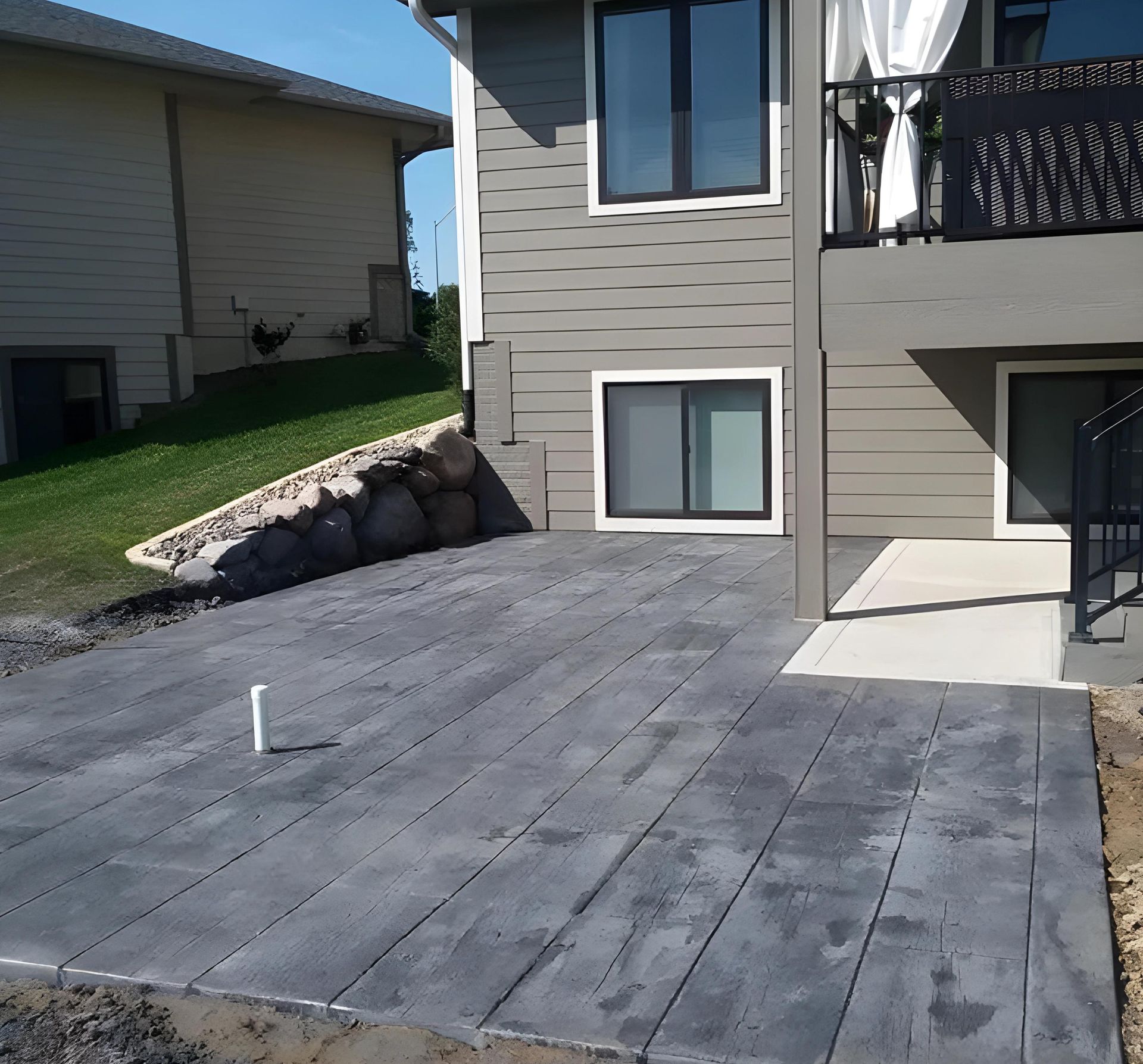 A house with a concrete patio in front of it