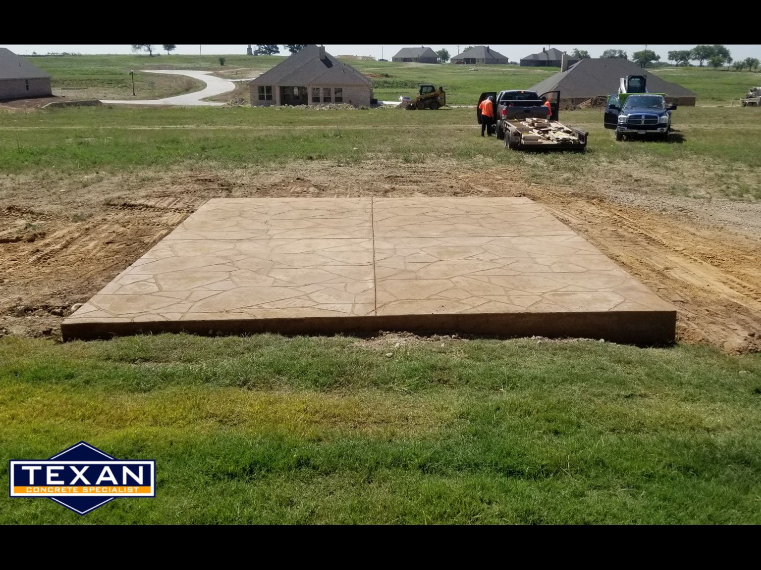 A large concrete slab is sitting in the middle of a grassy field.