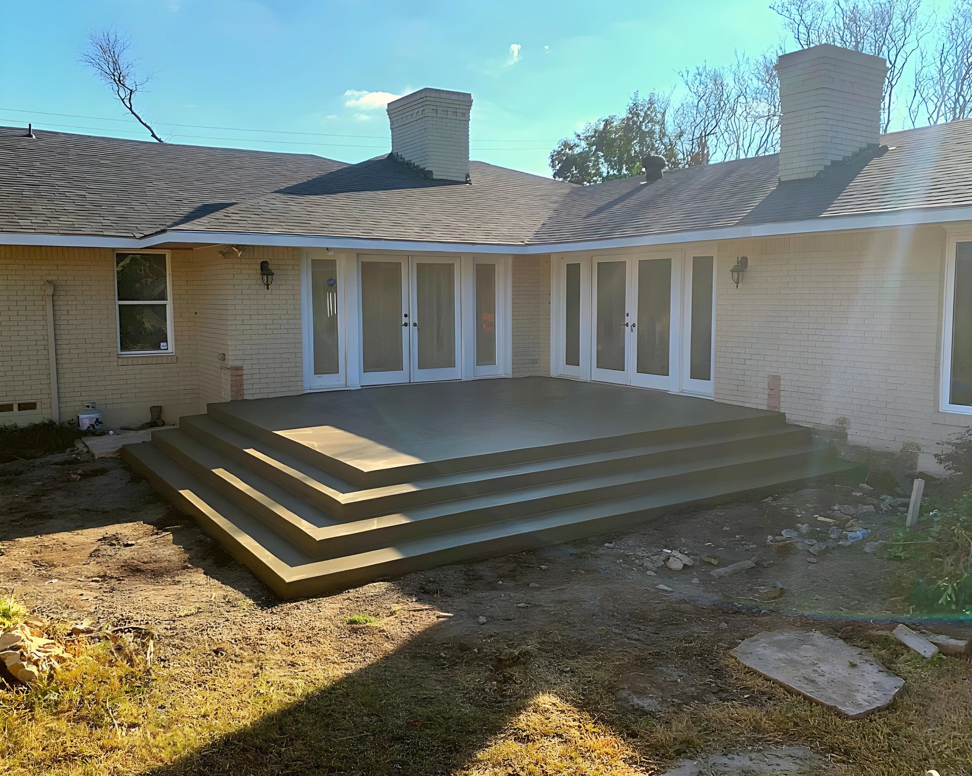 A house with a patio and stairs in front of it