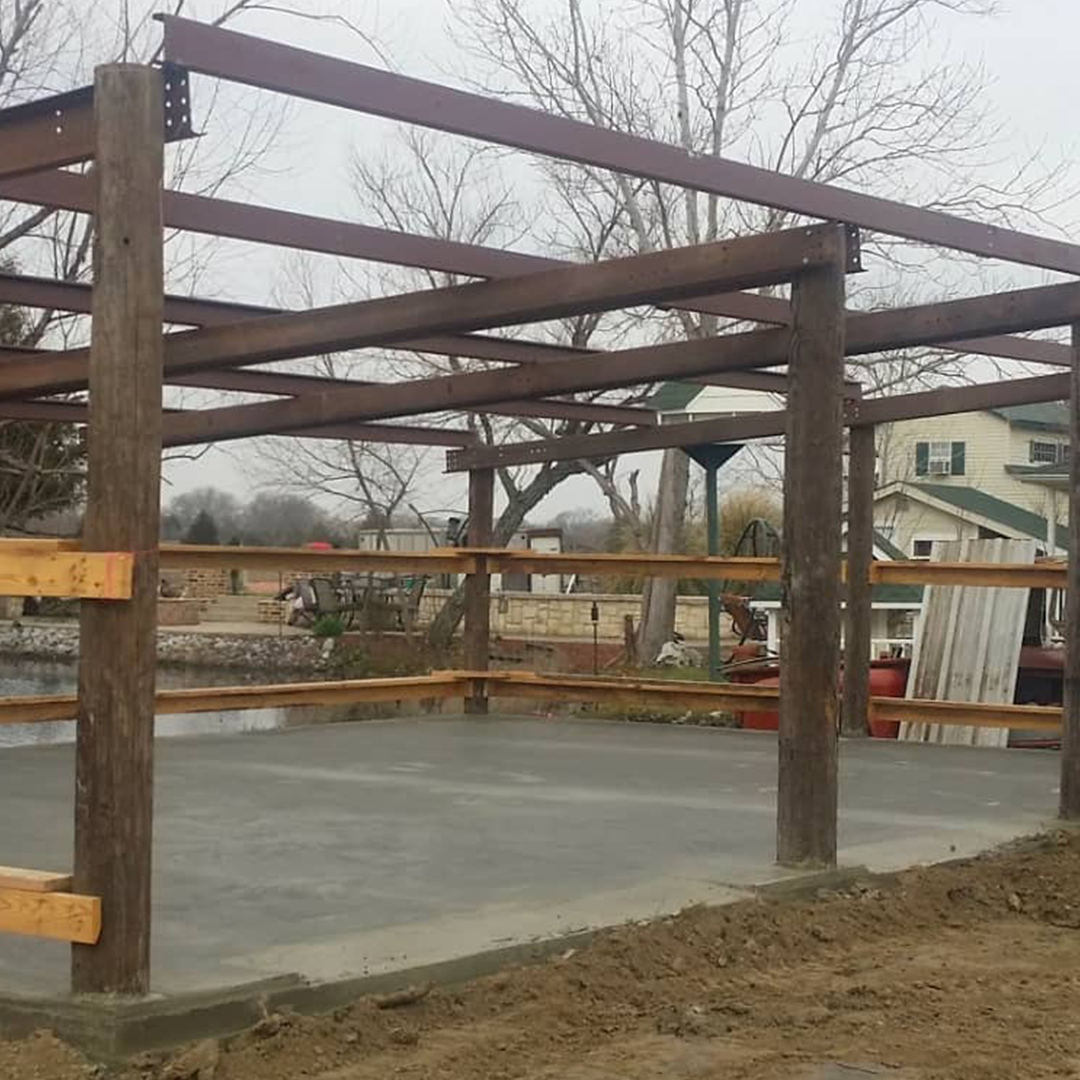 A wooden structure is sitting on top of a concrete floor.