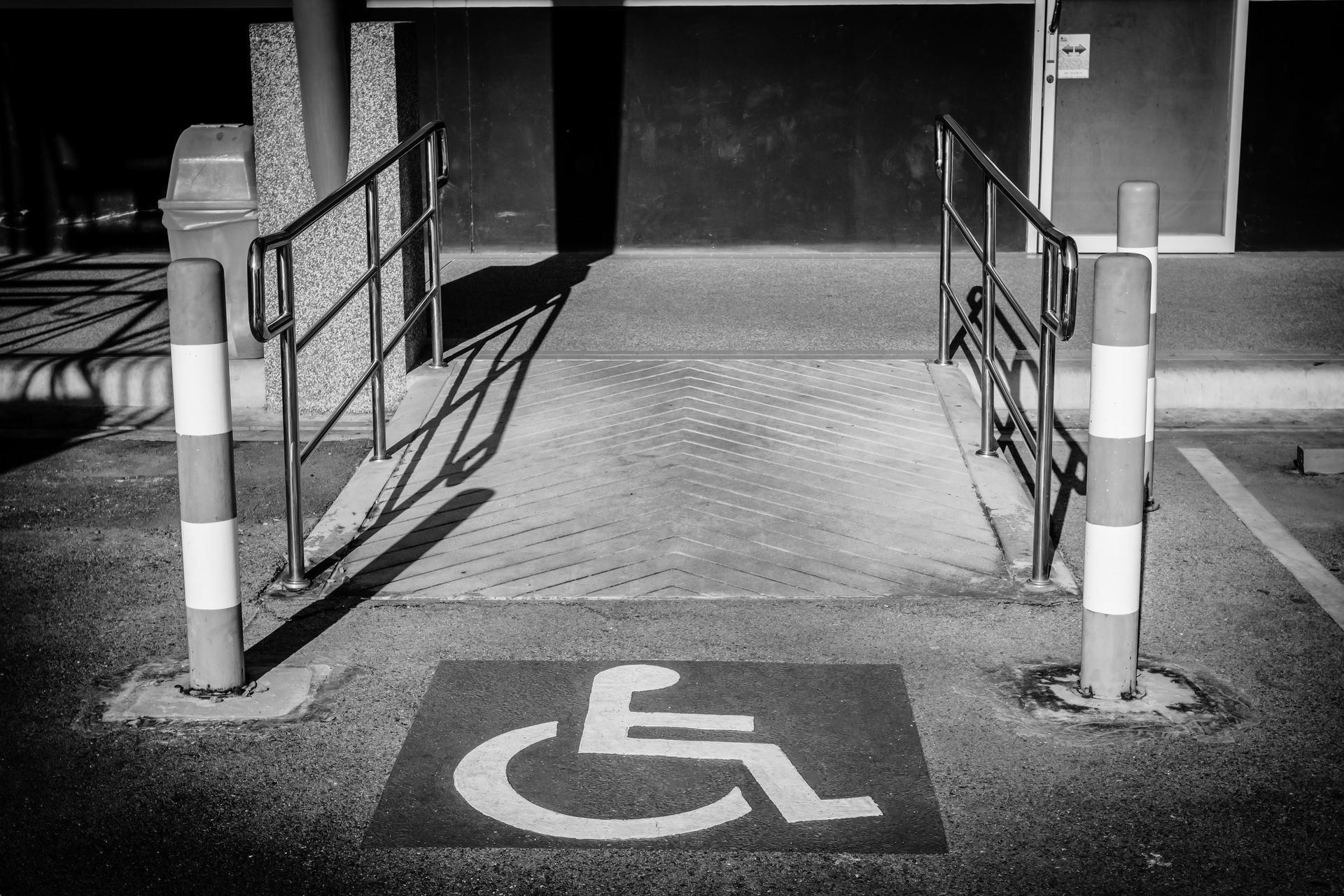 A black and white photo of a handicapped parking spot
