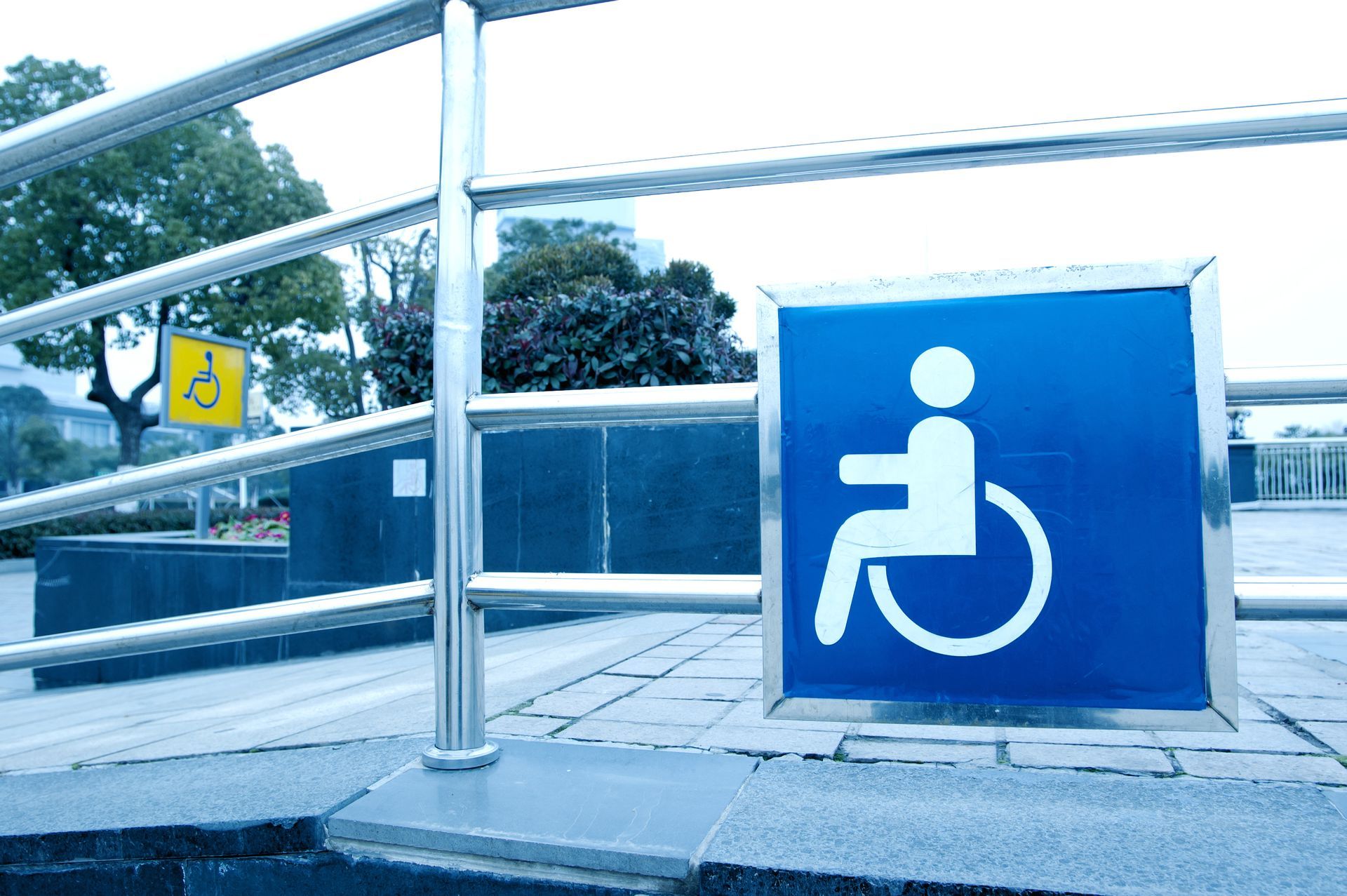 A blue sign with a person in a wheelchair on it