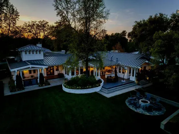 An aerial view of a large house with a fire pit in the backyard at dusk. - Sonia Immers, Top Realtor in Rocklin, CA