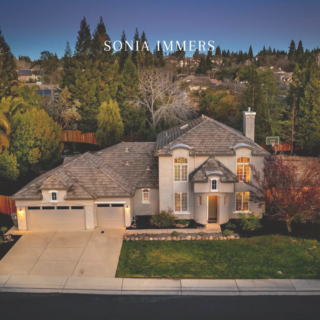 Aerial view of a beautiful home for sale in Greenbrae, Rocklin with a spacious yard and trees.