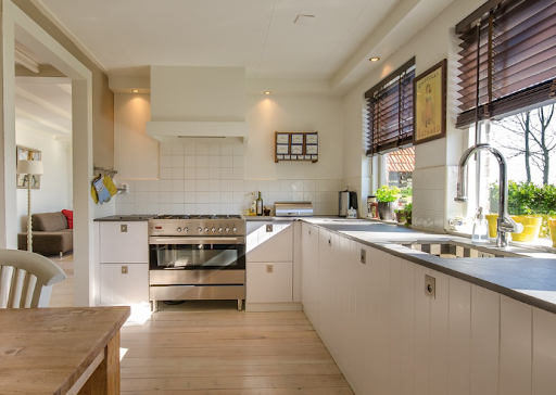 A kitchen with white cabinets & stainless steel appliances. Work with Sonia Immers to Discover Homes for Sale in Rocklin, CA
