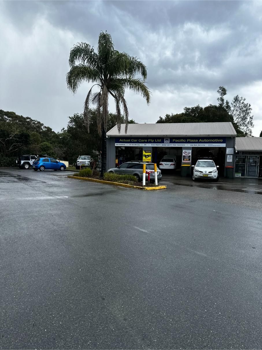 An Automotive Shop With Cars Parked in Front of It — Pacific Plaza Automotive in Port Macquarie, NSW
