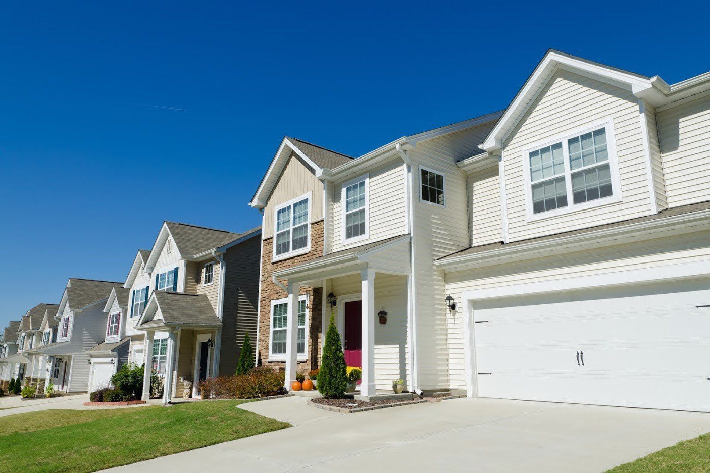A Row of Houses in A Residential Area with A Blue Sky in The Background - Rochester Hills, MI - J & B Doors