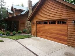 A Log Cabin with A Large Wooden Garage Door - Rochester Hills, MI - J & B Doors