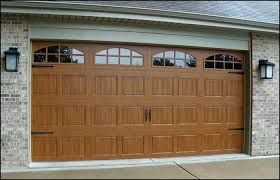 A Large Wooden Garage Door Is Sitting on Top of A Brick Building - Rochester Hills, MI - J & B Doors