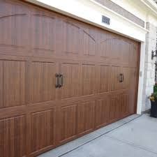 A Large Wooden Garage Door Is Sitting on The Side of A House - Rochester Hills, MI - J & B Doors