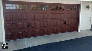 A Large Brown Garage Door Is Sitting on The Side of A House - Rochester Hills, MI - J & B Doors