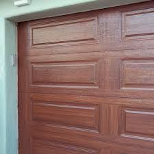 A Close up Of a Wooden Garage Door on A House - Rochester Hills, MI - J & B Doors