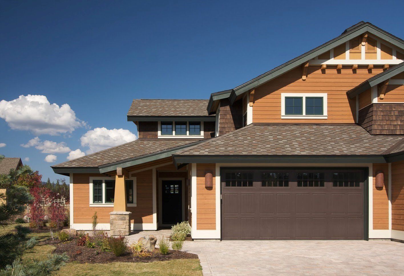 A Large House with A Brown Garage Door and A Blue Sky in The Background - Rochester Hills, MI - J & B Doors