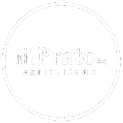 Logo circolare tenue con la scritta “il Prato agriturismo” in grigio chiaro su sfondo bianco.