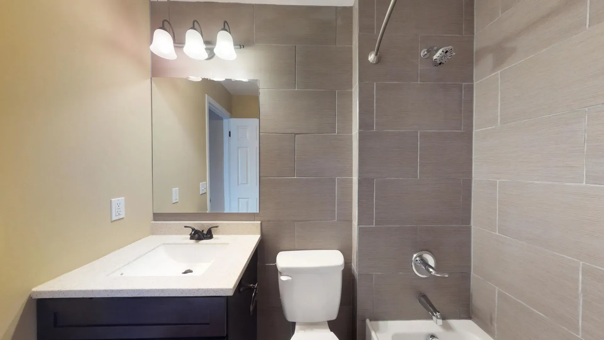 A bathroom with a toilet , sink , and shower.