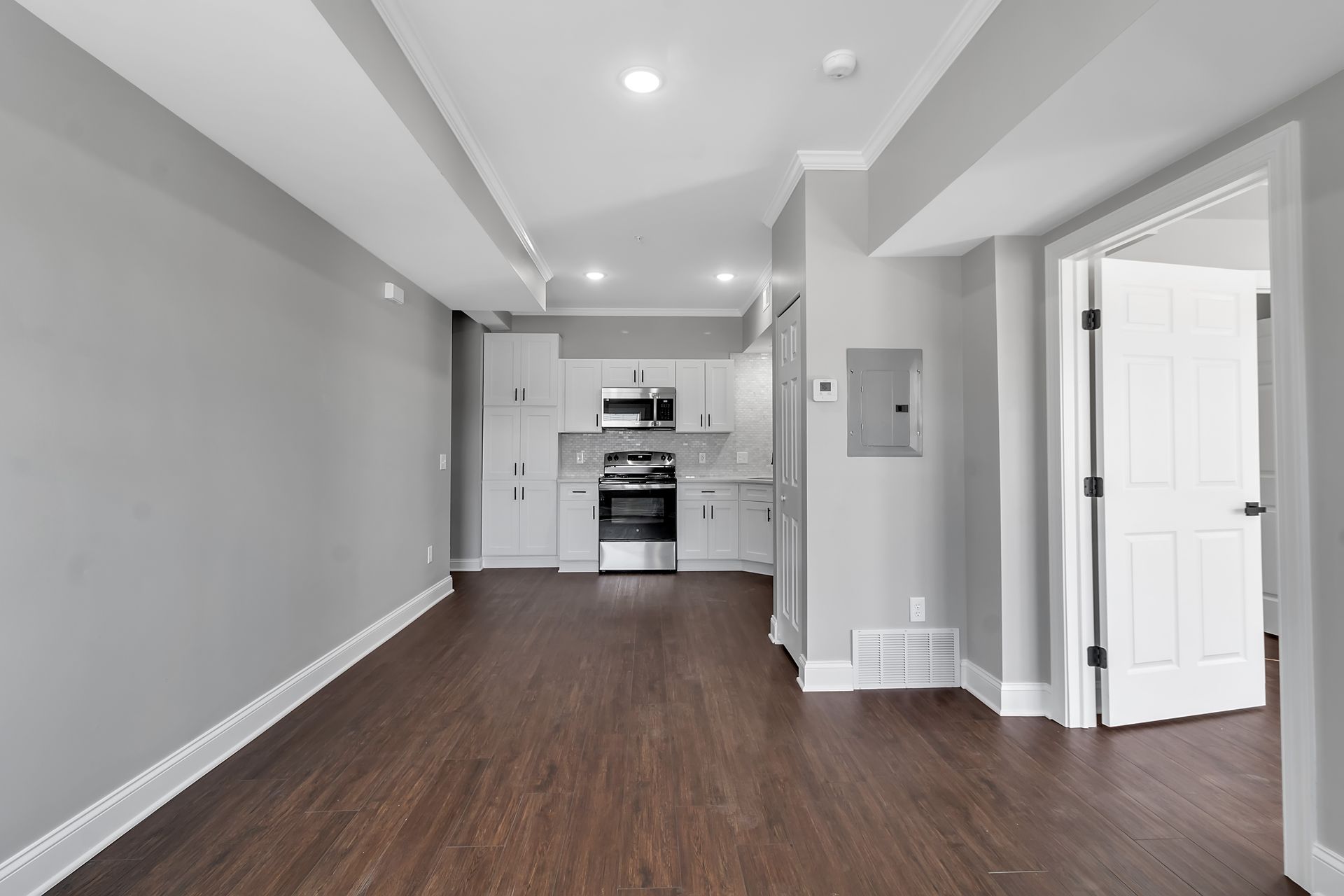 Living area with subtle recessed lighting and updated finishes