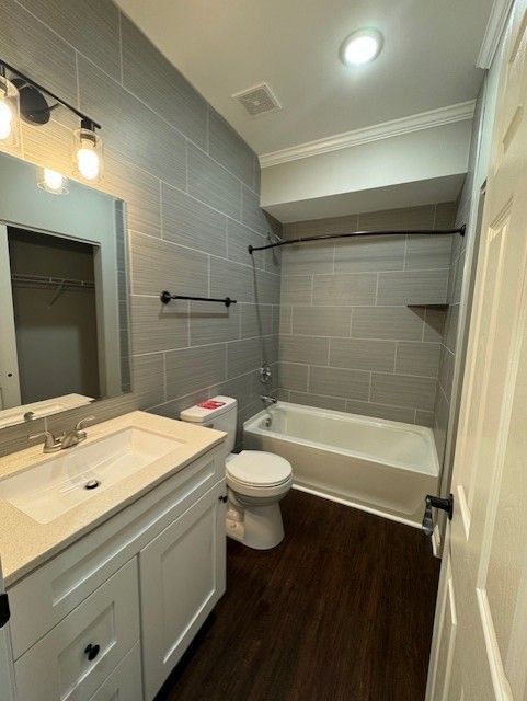 Bathroom with tiled shower wall and sleek vanity