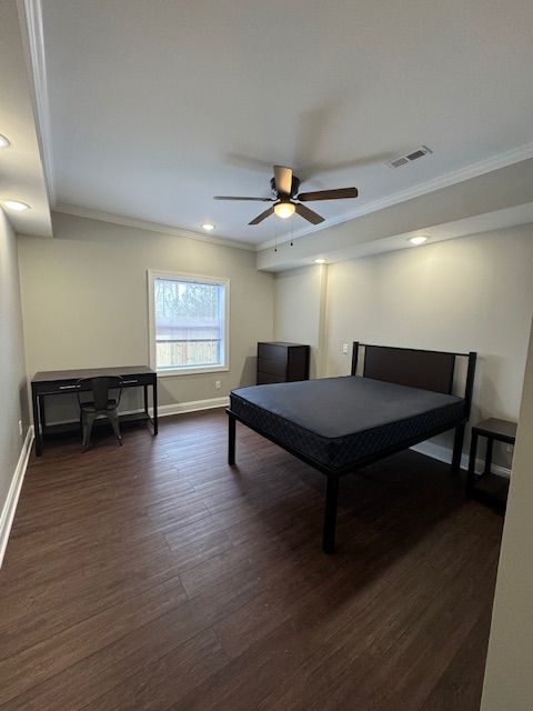 Apartment bedroom with modern flooring and large window